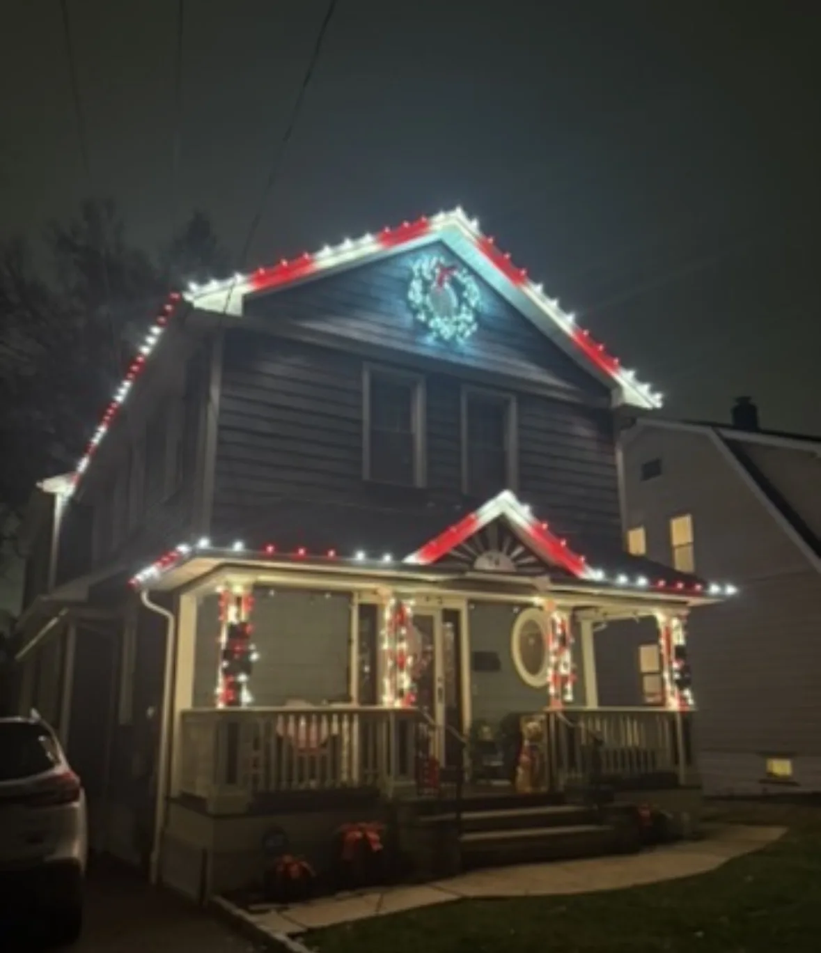 Christmas Lighting in Orange: Close-up: clips and C9 bulbs on gutter line