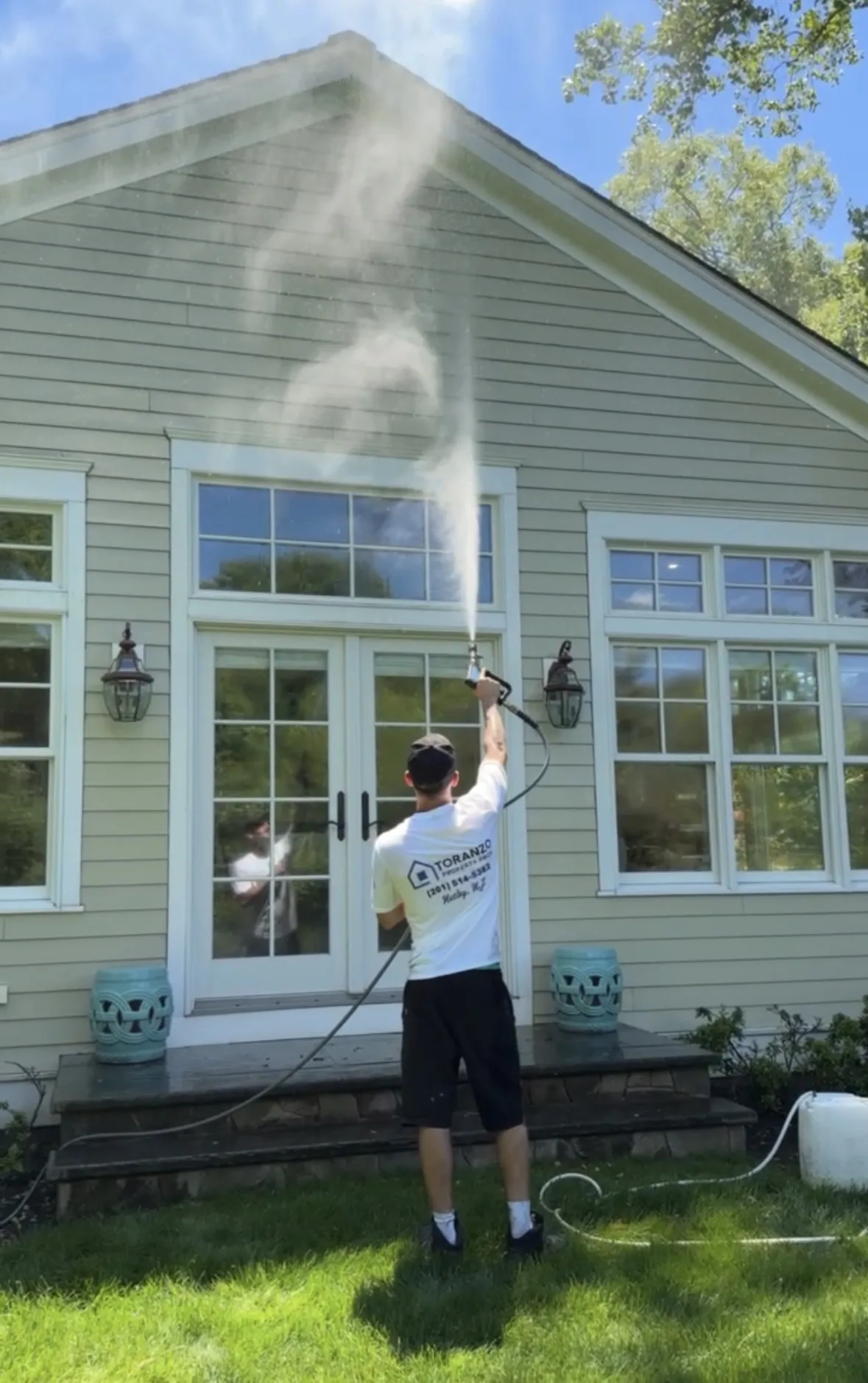 House Washing in Paramus: Crew soft washing a two-story colonial